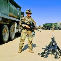 Antoni Pestka in U.S. Army uniform, beside a convoy