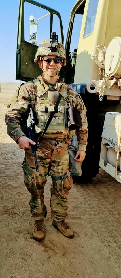 Antoni Pestka in U.S. Army uniform, beside a military truck